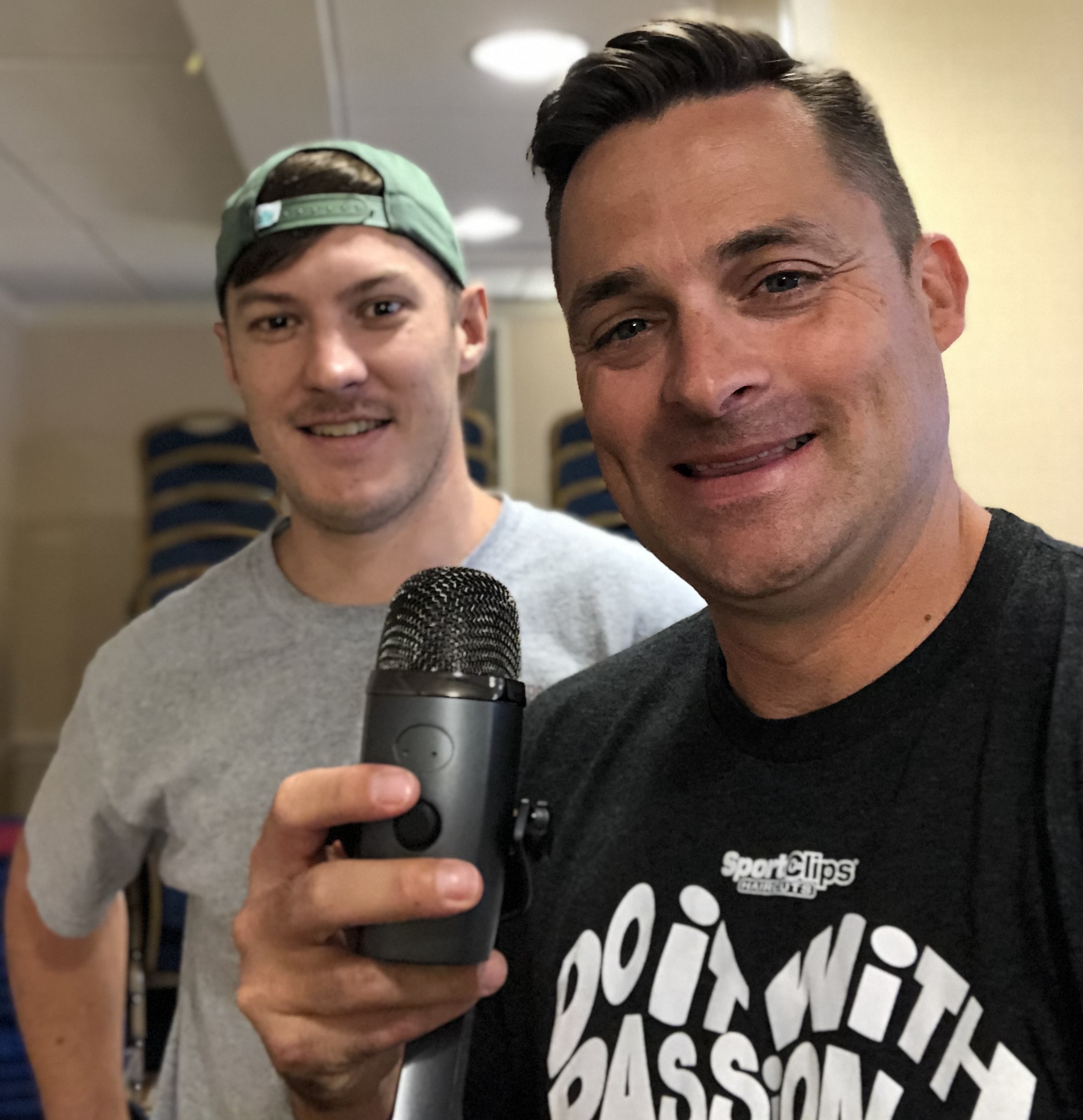 Chad Jordan and Taylor Clinker holding a microphone